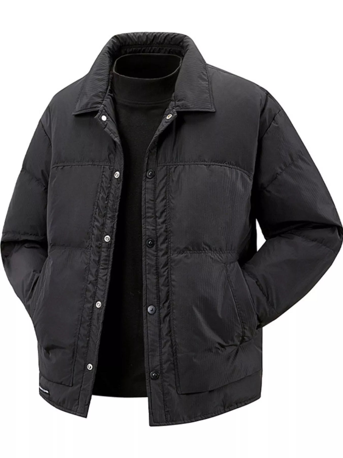 Black snap-front puffer jacket styled over a black turtleneck, front view
