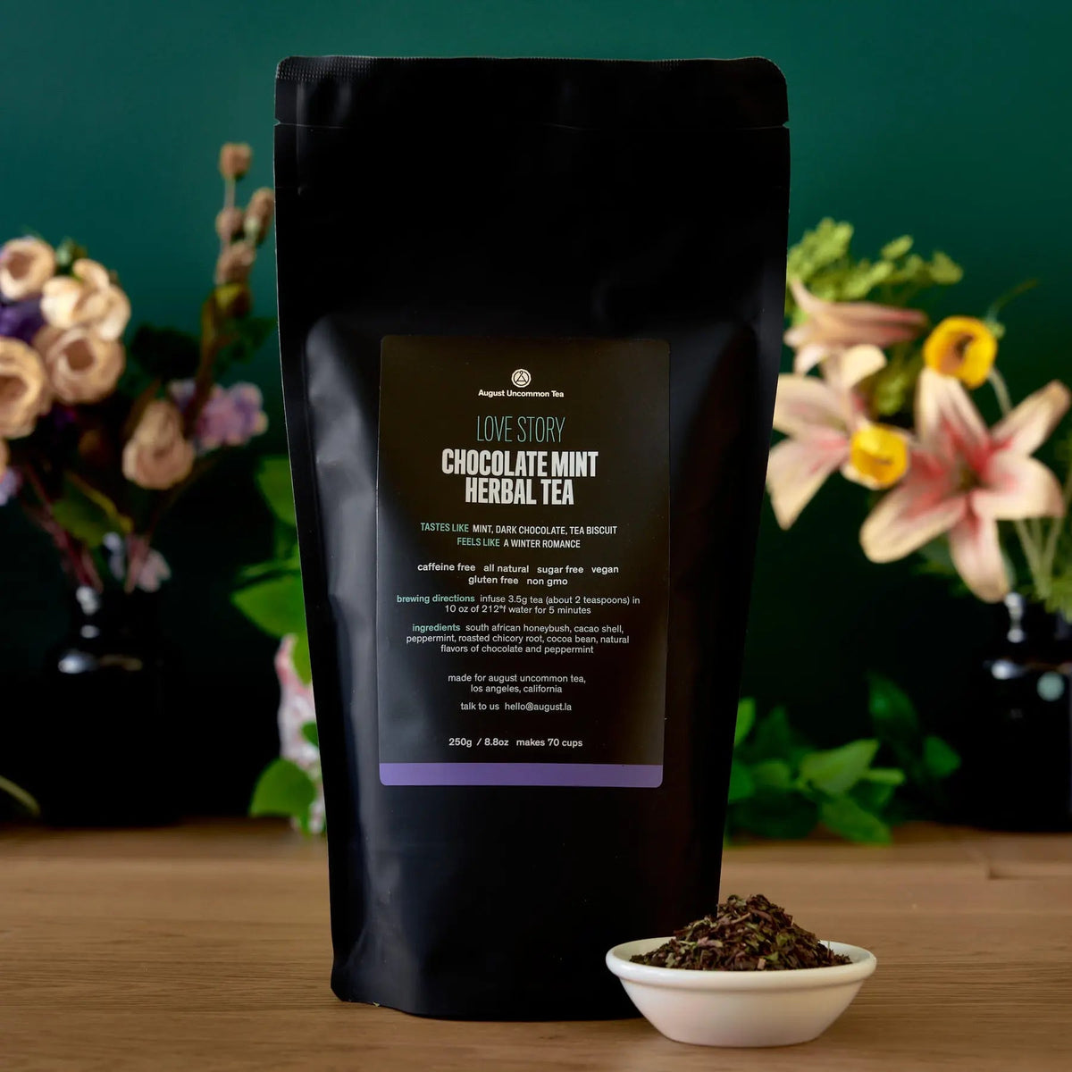 August Uncommon Tea Love Story chocolate-mint herbal tea 70-cup bag beside a bowl of loose blend