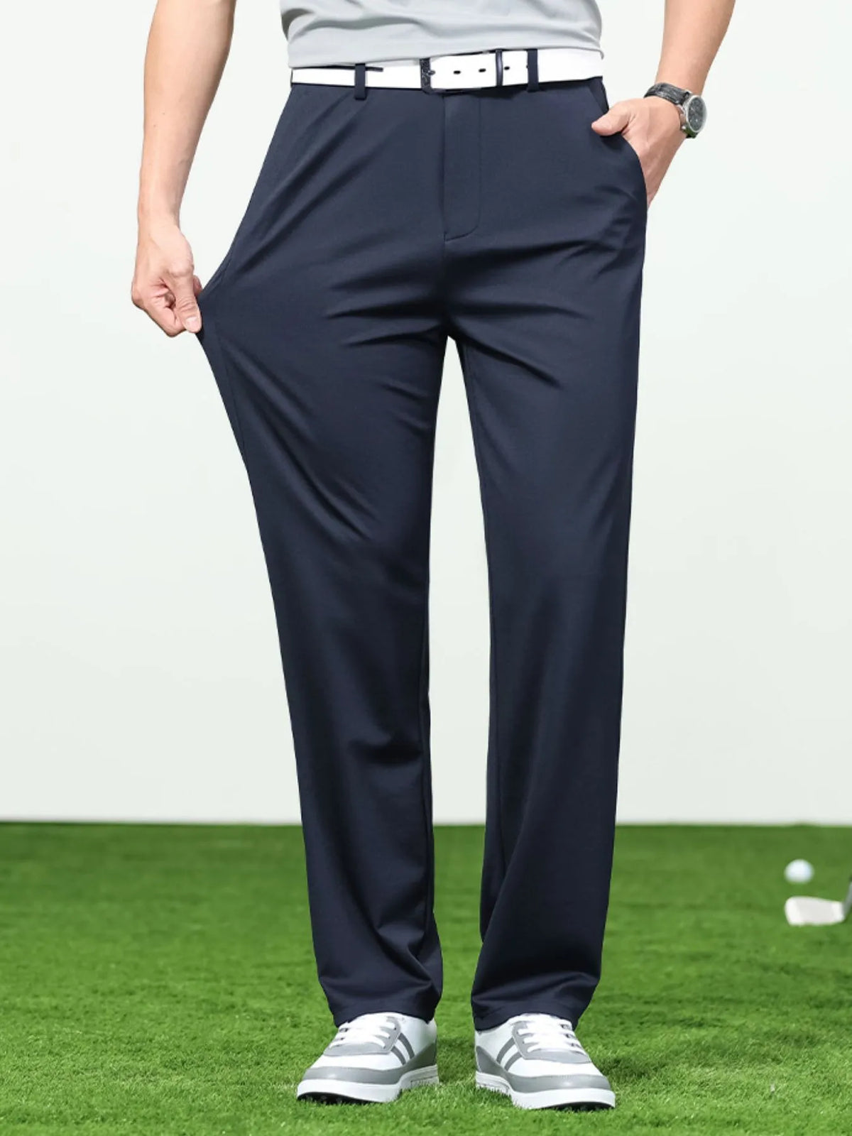 Dark blue trousers with fabric pulled outward at the thigh.