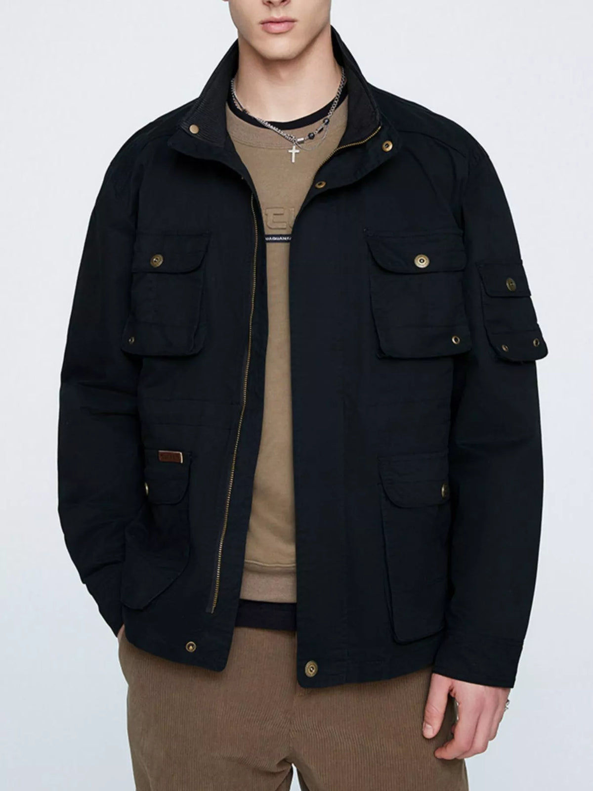 Black multi-pocket men's jacket shown open from the front; shirt, trousers and necklaces are not included.
