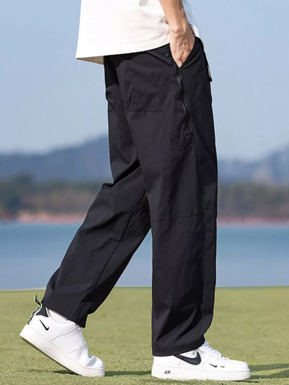 Black wide-leg trousers, side rear walking view on model