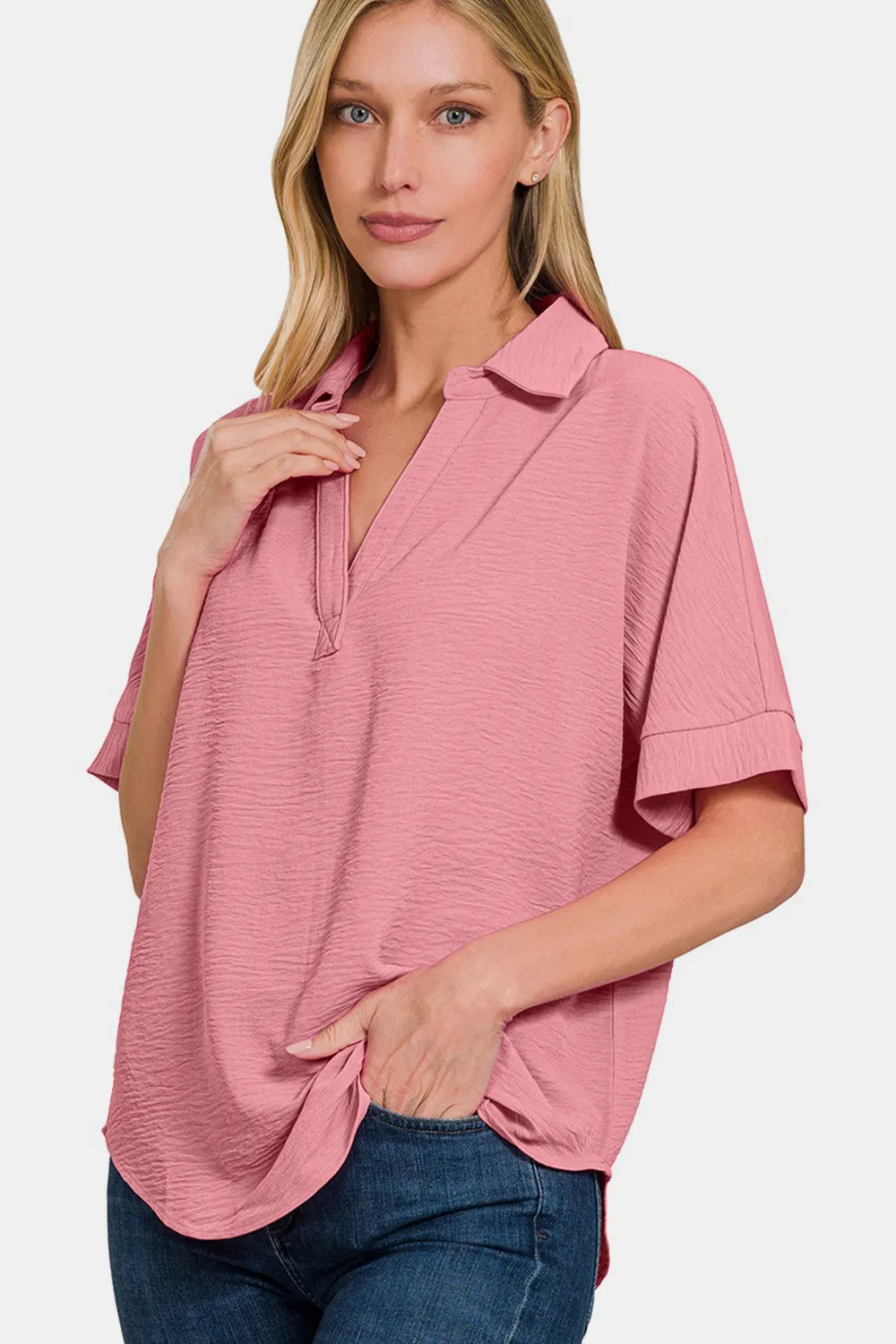 Light-rose textured collared short-sleeve top, angled view.