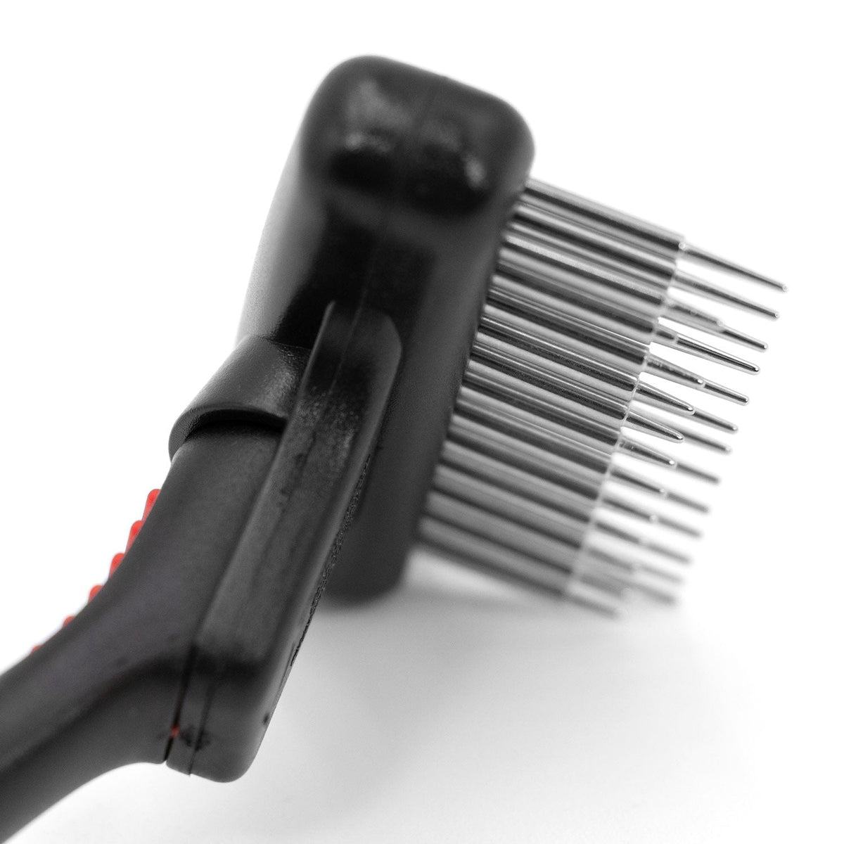 Close-up of the long and short pins on the Jeffers double-row undercoat rake.