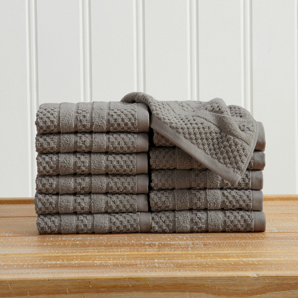 Dark Grey Giuliana Collection checkered jacquard washcloths folded and stacked.