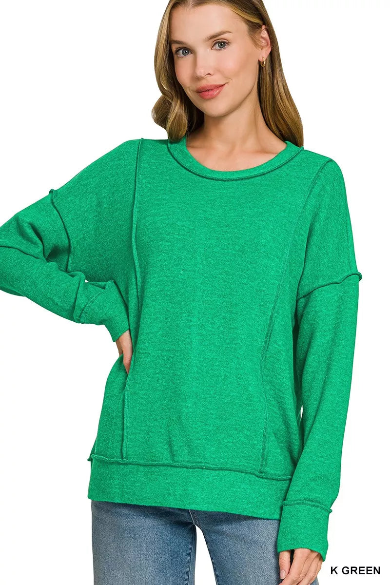 Front of the K Green Zenana drop-shoulder sweater with exposed seams; jeans and jewelry are not included.