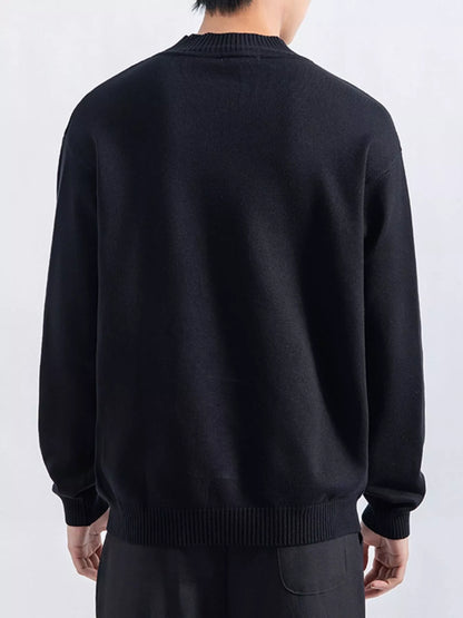 Men's Black minimalist mock-neck sweater, back view. Trousers are styling items and are not included.