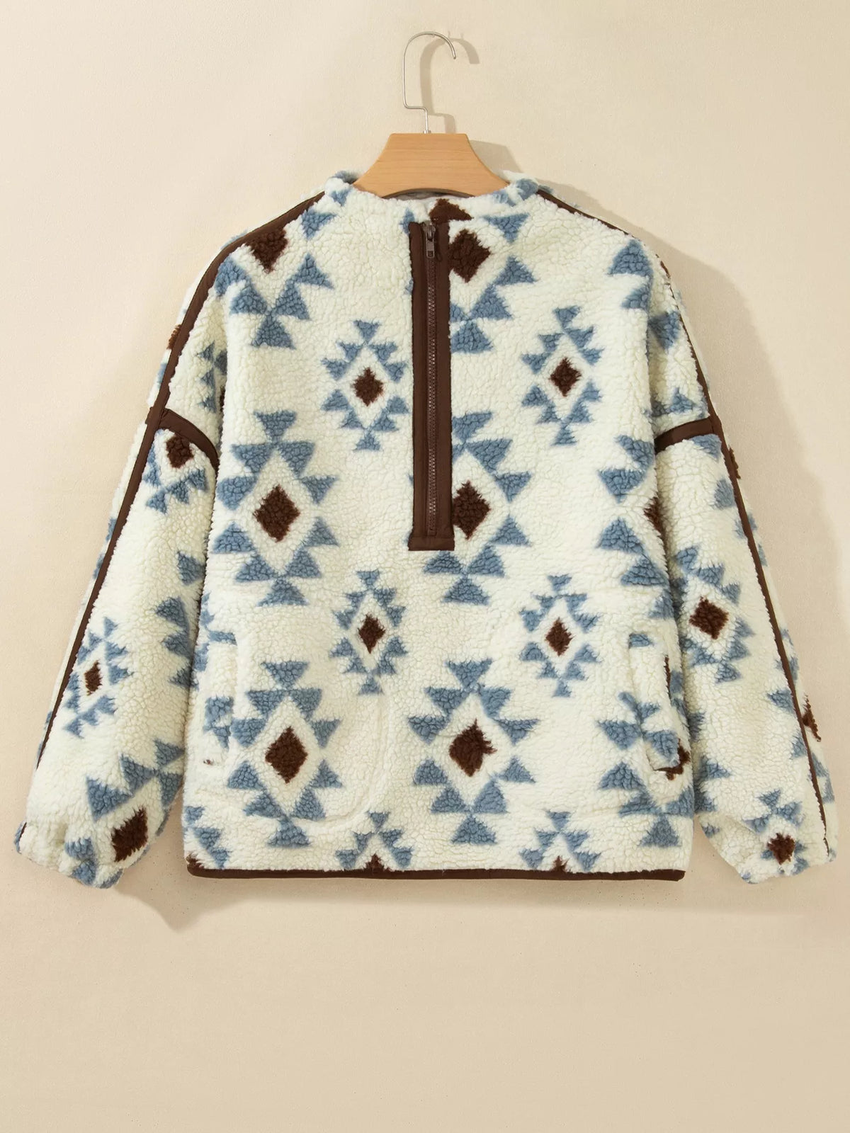 Front of the beige SYNZ geometric sherpa sweatshirt on a hanger.