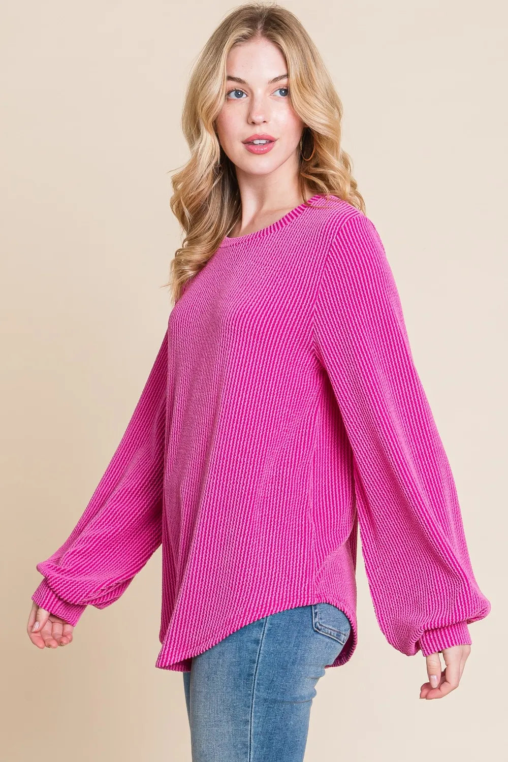 Angled view of the fuchsia ribbed long-sleeve top