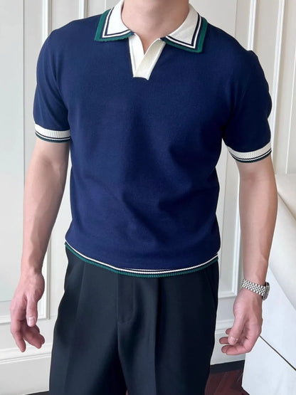 Royal Blue short-sleeve knit polo with white and green striped collar and sleeve trim, worn on a model. Shirt only.