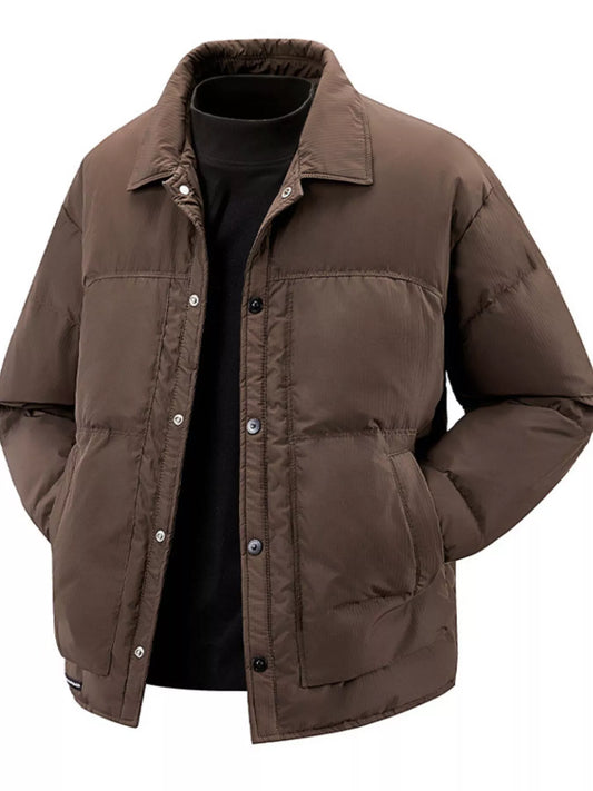 Caramel brown snap-front puffer jacket styled over a black turtleneck, front view
