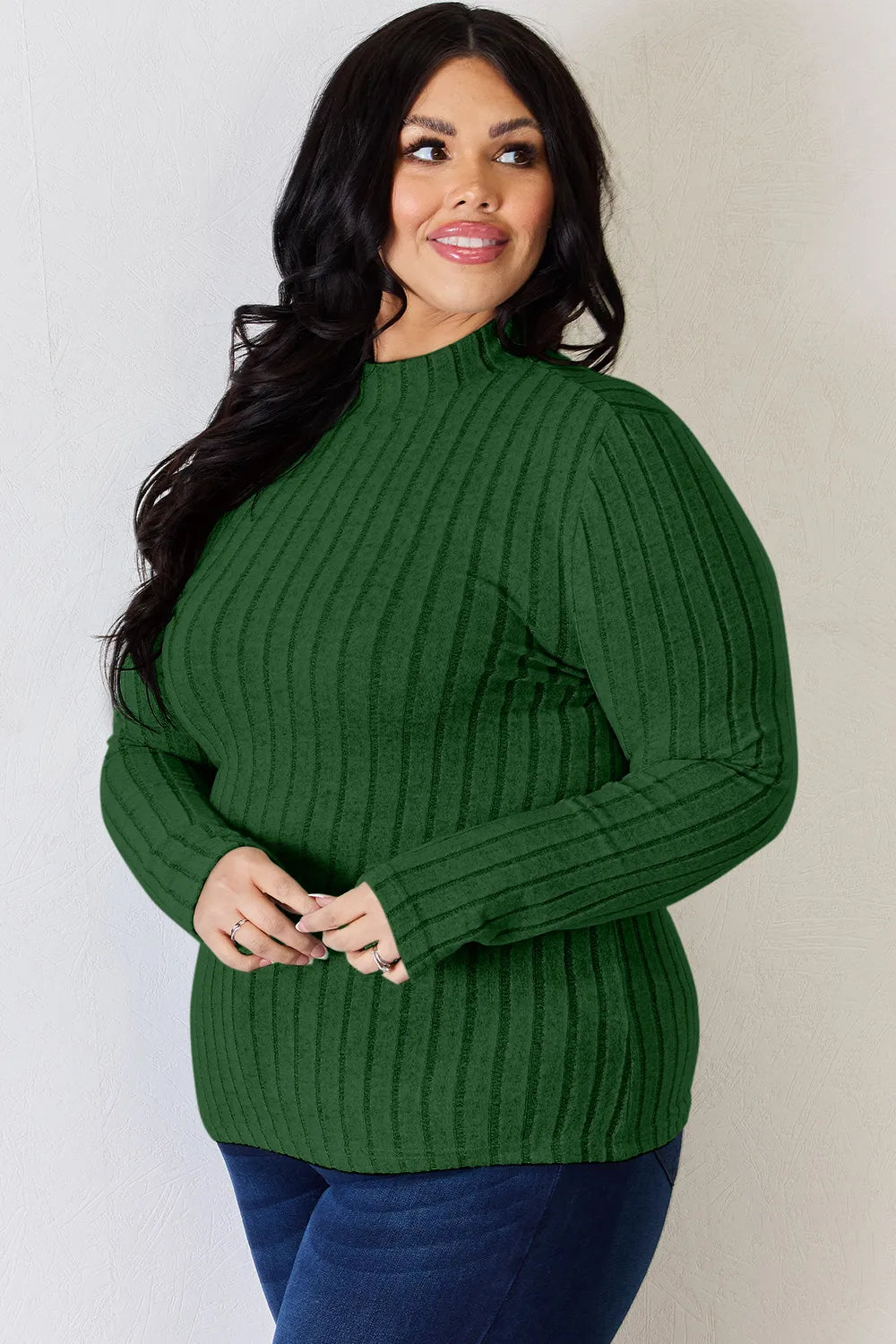 Green ribbed mock-neck long-sleeve top, product view; one top included, jeans and accessories excluded