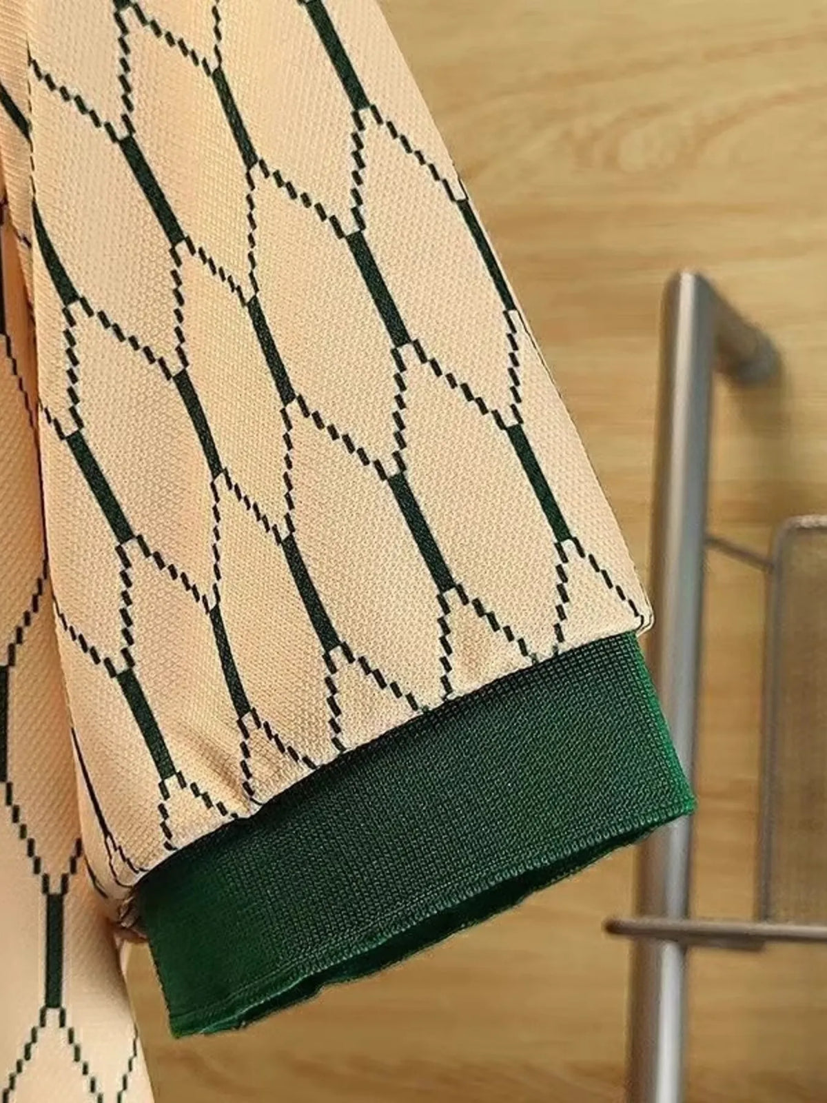 Close view of the Green variant's diamond-pattern fabric and dark green ribbed sleeve edge.