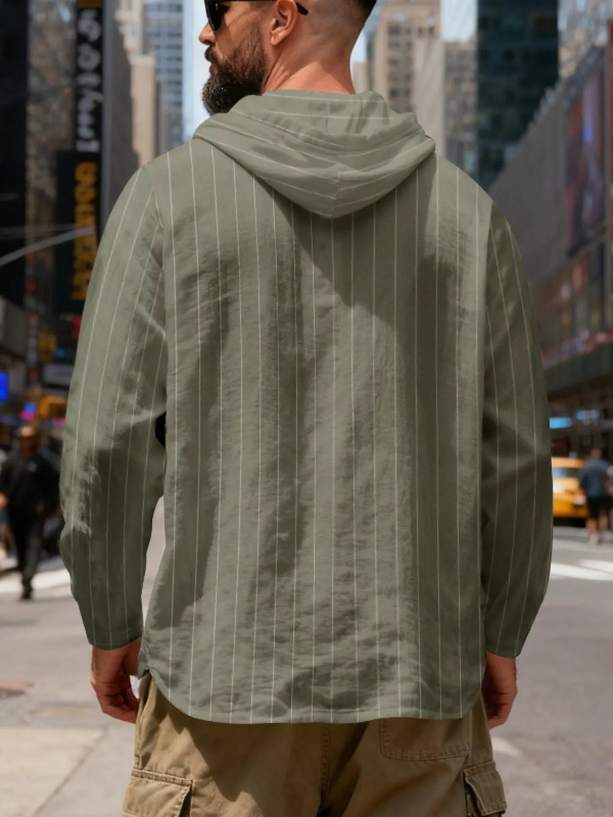 Men's striped Henley hoodie in Army Green — back view showing the hood and vertical stripe pattern; trousers and accessories are styling only.