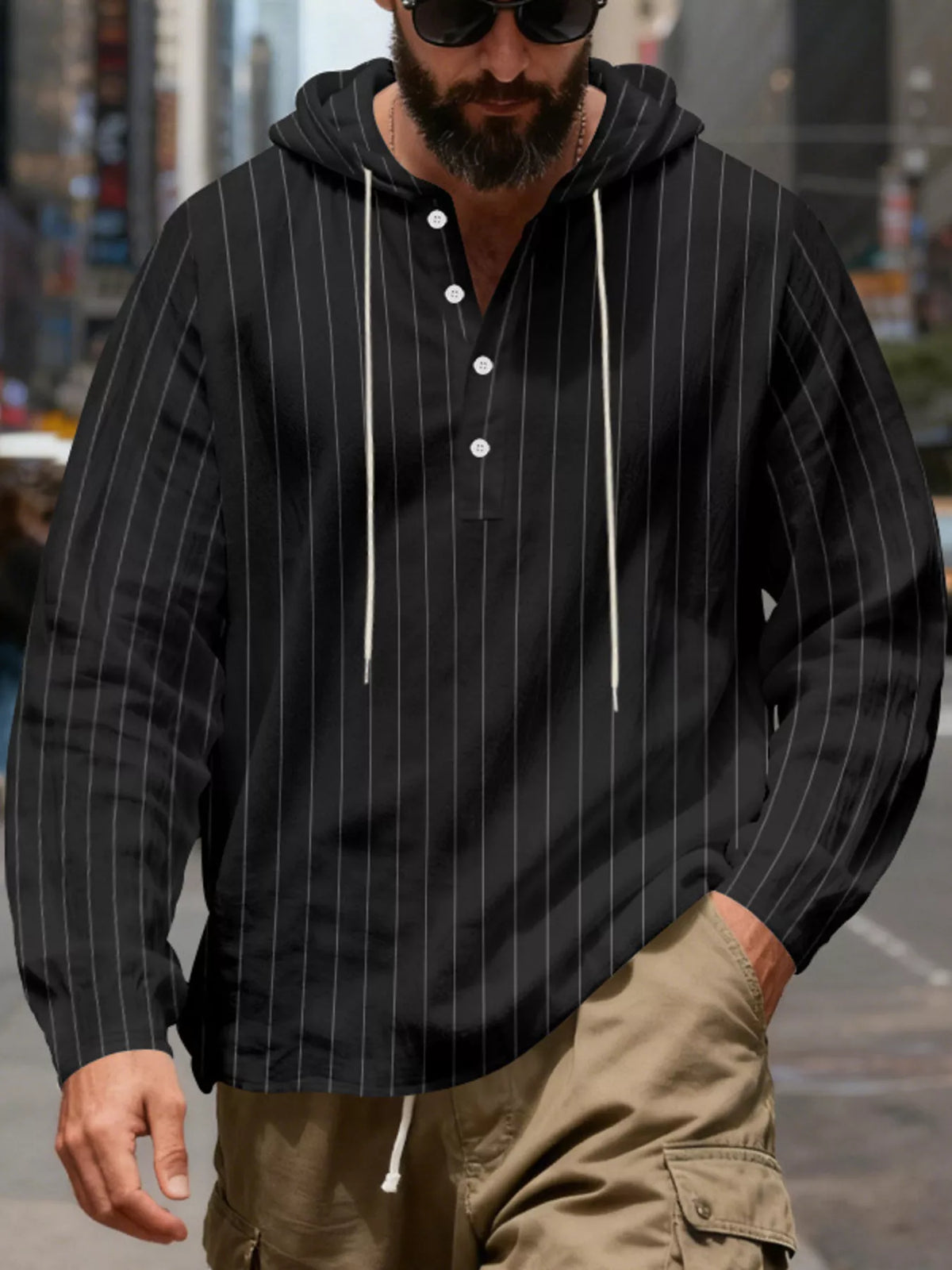 Men's striped Henley hoodie in Black — neckline and upper front view showing the hood and buttoned neckline; trousers and accessories are styling only.