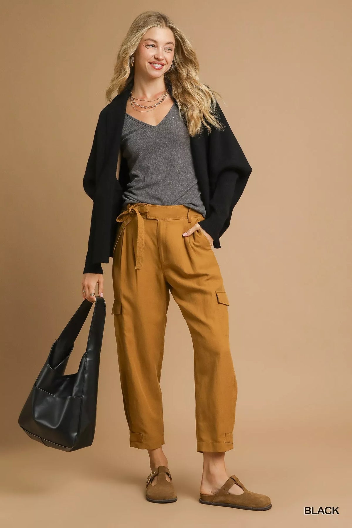 Full-length styling view of the black Umgee cardigan; top, trousers, bag and shoes are not included.