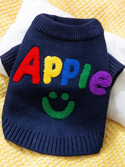 Navy pet sweater with colorful Apple lettering and a smile graphic, shown flat.