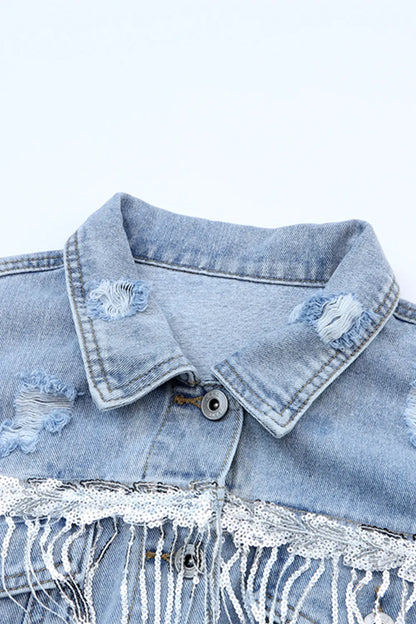 Close-up of the denim jacket pointed collar, distressed patches, metal button and silver sequin trim.