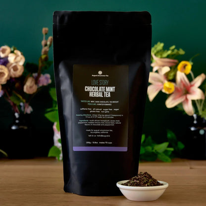 August Uncommon Tea Love Story chocolate-mint herbal tea 70-cup bag beside a bowl of loose blend
