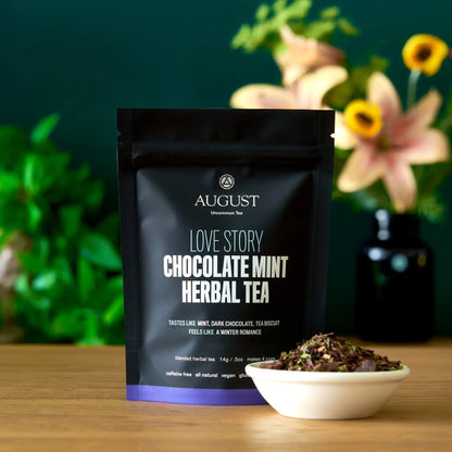 August Uncommon Tea Love Story four-cup deluxe sample pouch beside a bowl of loose chocolate-mint blend
