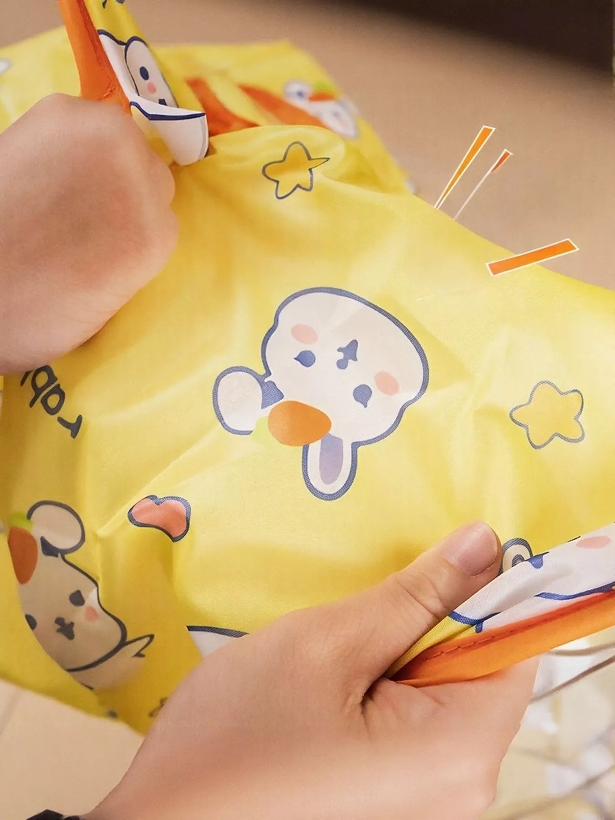 Close-up of yellow Rabbit Pattern polyester fabric and orange edging