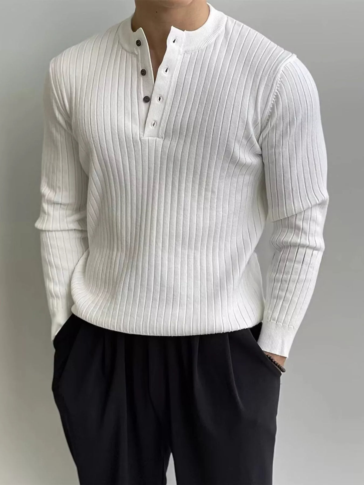 White ribbed long-sleeve knit top with button detailing, modelled front view. One top only; styling pieces not included.