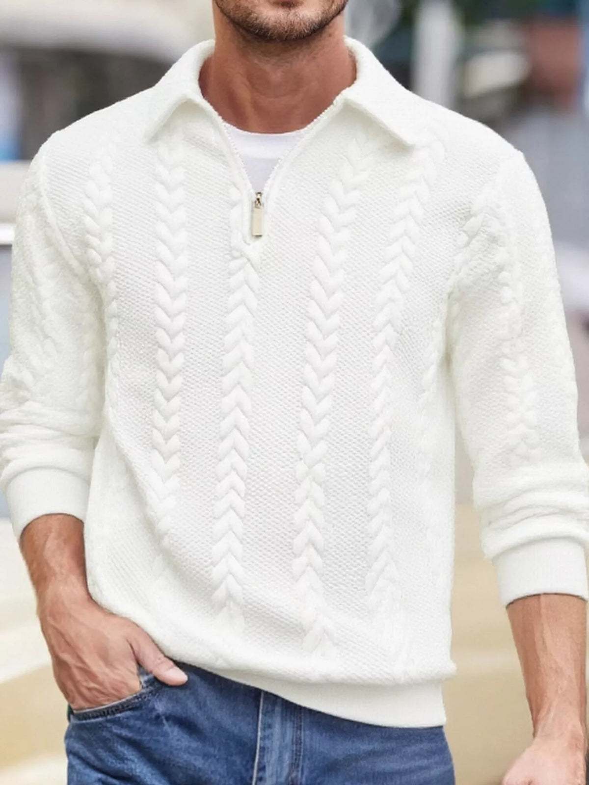 Men's white cable-textured quarter-zip pullover with pointed collar and ribbed cuffs and hem, shown on a model.