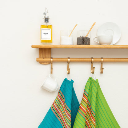 Blue & Green Salsa Stripe kitchen towels hanging in a kitchen