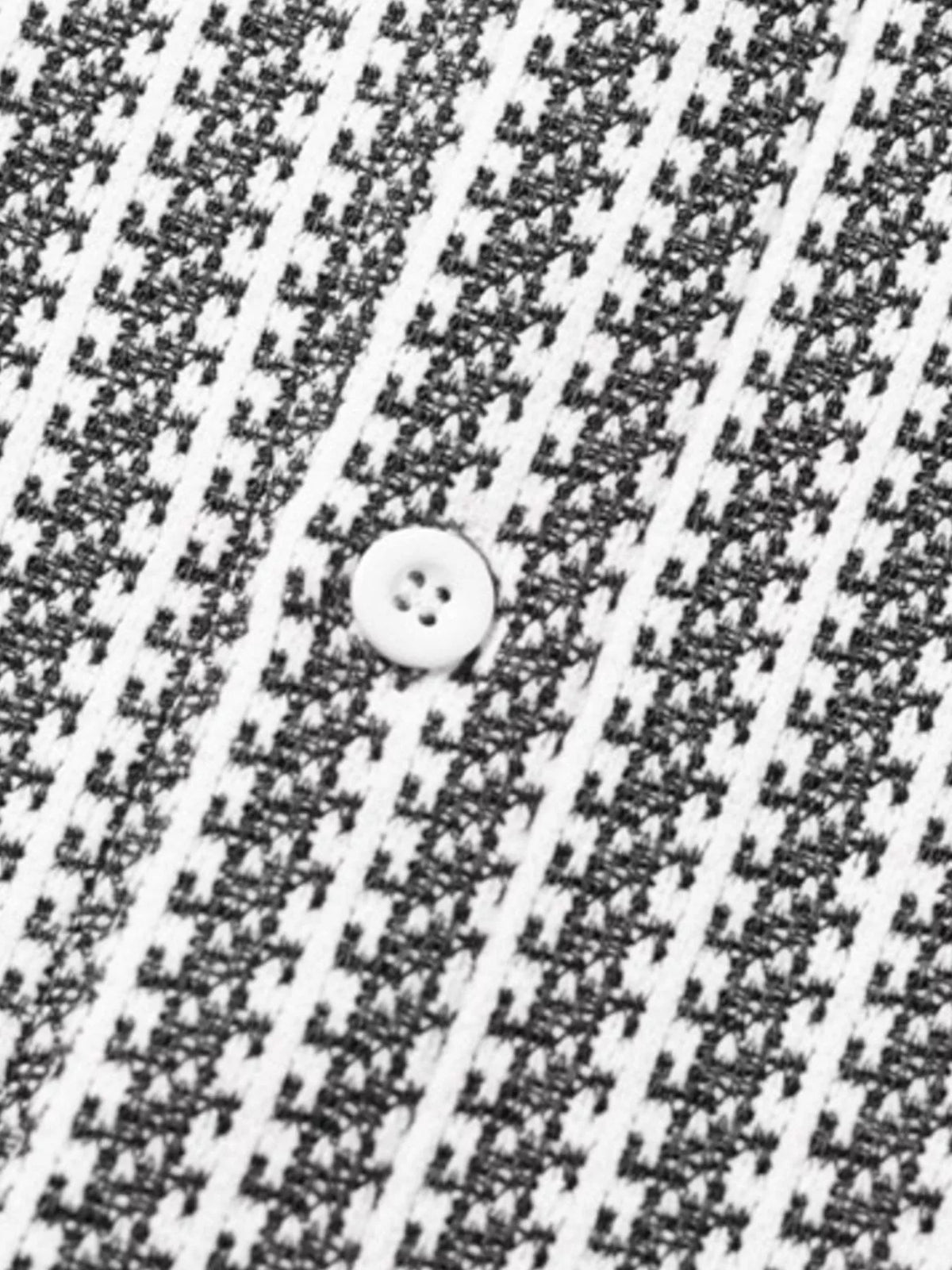 Close-up of the White-patterned shacket fabric and a front button.