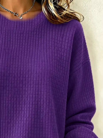 Close-up of the Purple sweatshirt's crew neckline, waffle-knit texture and sleeve.