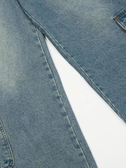 Close-up of the washed blue denim legs and inner-leg seam.