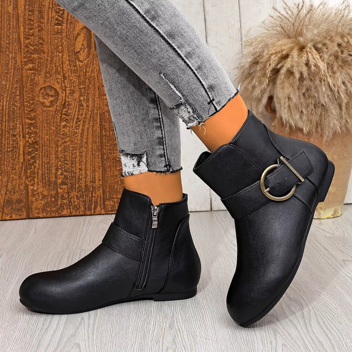 Black round-toe ankle boots with side zipper and buckle