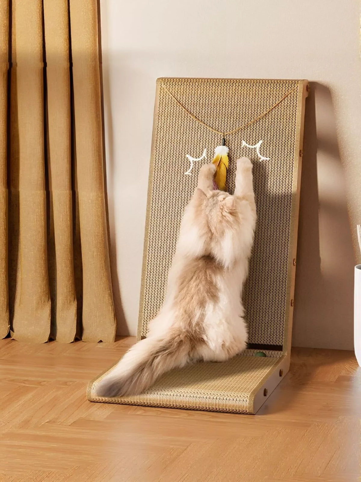 Camel cat scratching board with dangling toy, shown in use; cat and room props not included