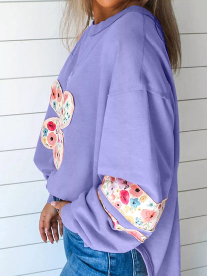 Lavender floral applique sweatshirt, side view with drop shoulder and sleeve patch.