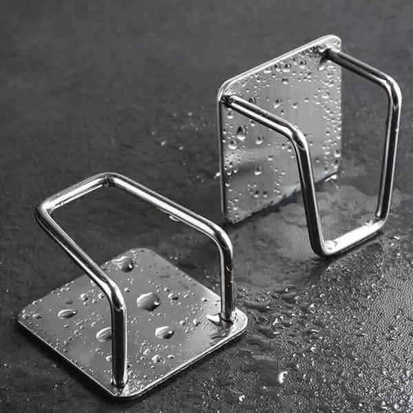 Two empty stainless steel sponge holders; shown with water droplets.