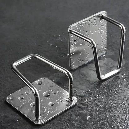 Two empty stainless steel sponge holders; shown with water droplets.