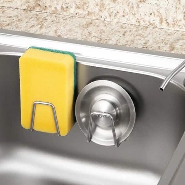 Sink-side use example with a holder, sponge and drain stopper; cleaning items and sink are not included.