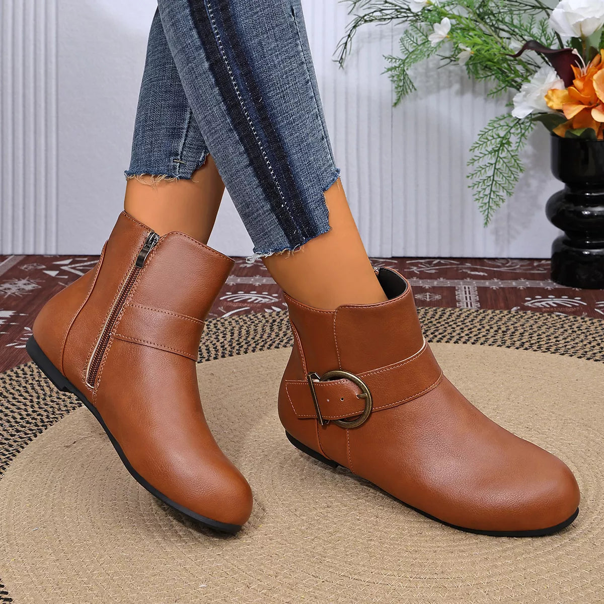 Brown ankle boots showing round toes and buckle detail
