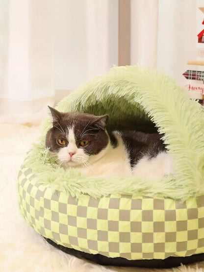 Close view of the plush-lined Green pet nest with a cat inside.