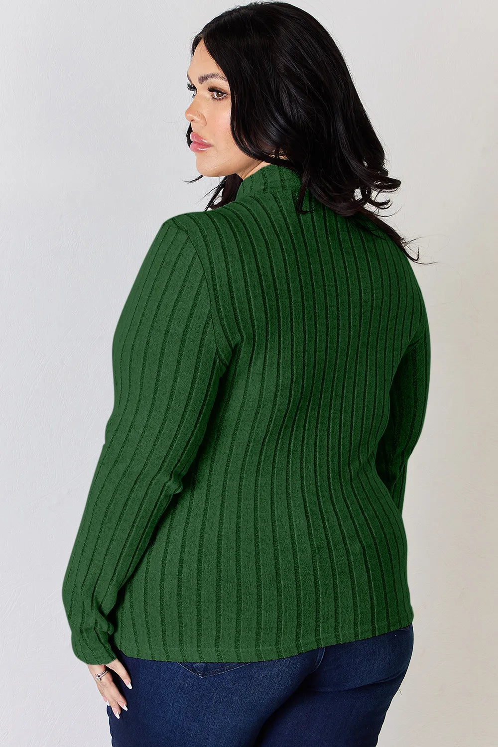 Green ribbed mock-neck long-sleeve top, product view; one top included, jeans and accessories excluded