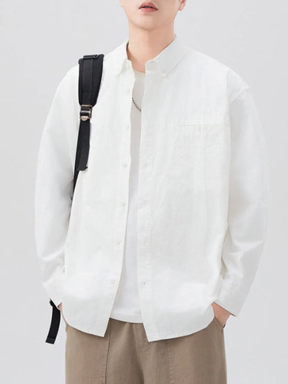 White long-sleeve shirt open over a white T-shirt, front view with bag strap