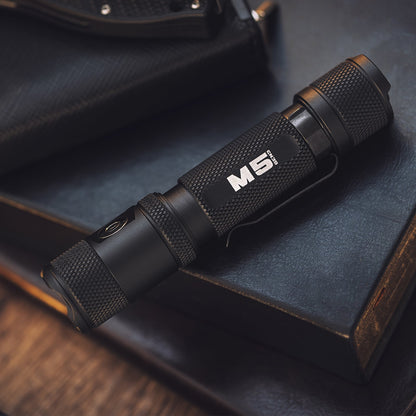 Close-up of the black Powertac M5 Gen3 flashlight body and lens