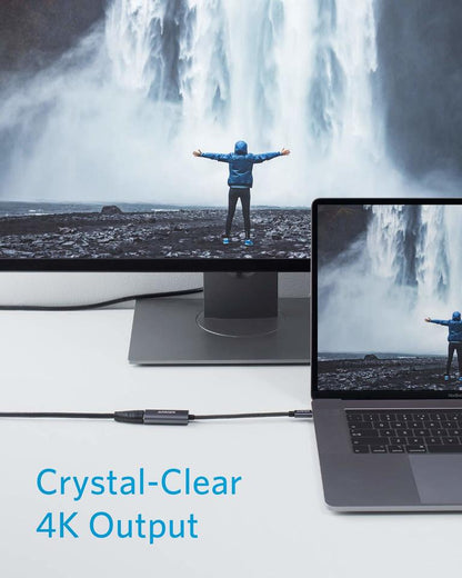 Anker USB-C to HDMI adapter connecting a laptop to an external monitor; output up to 4K with compatible equipment.