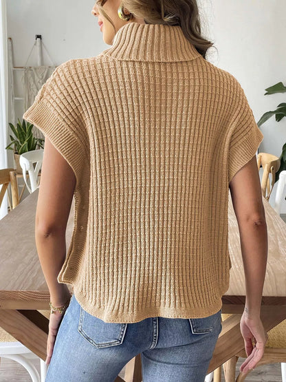 Back view of the camel ribbed turtleneck sweater vest; jeans are styling only.