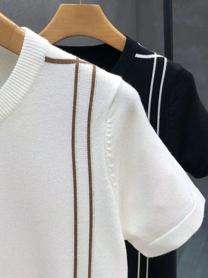 Close-up of the White contrast-trim T-shirt neckline and shoulder, with Black color option behind.