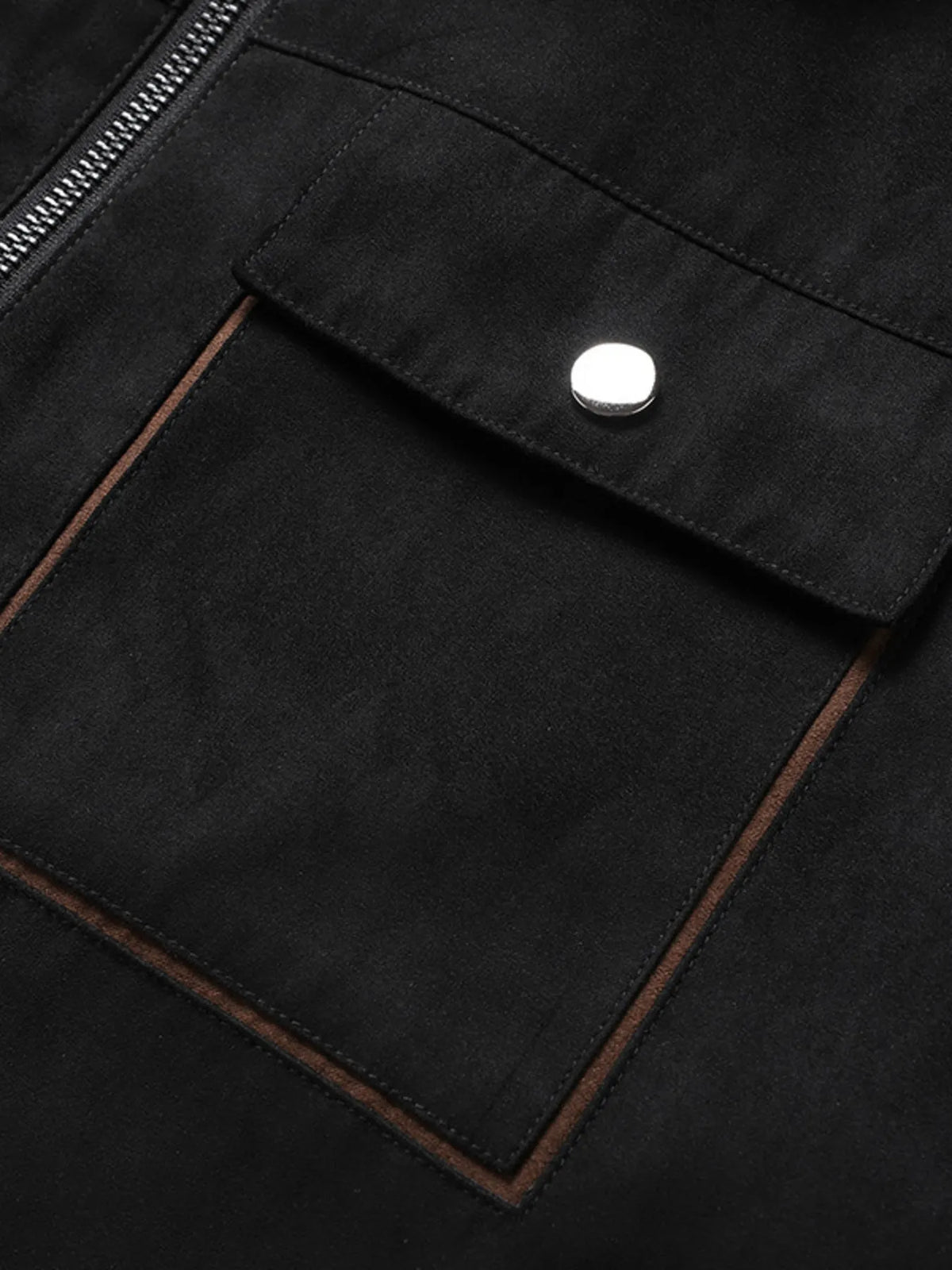 Close-up of the Black jacket's flap chest pocket and snap button.