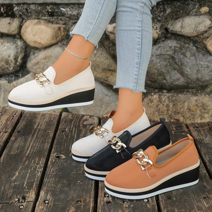 Beige round-toe wedge loafers worn with black and brown colour options displayed alongside; only one selected pair is sold.