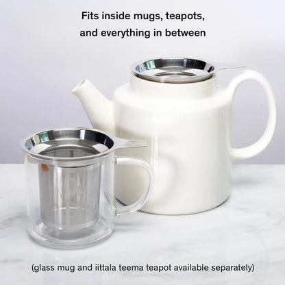Stainless tea infuser shown with a mug and teapot