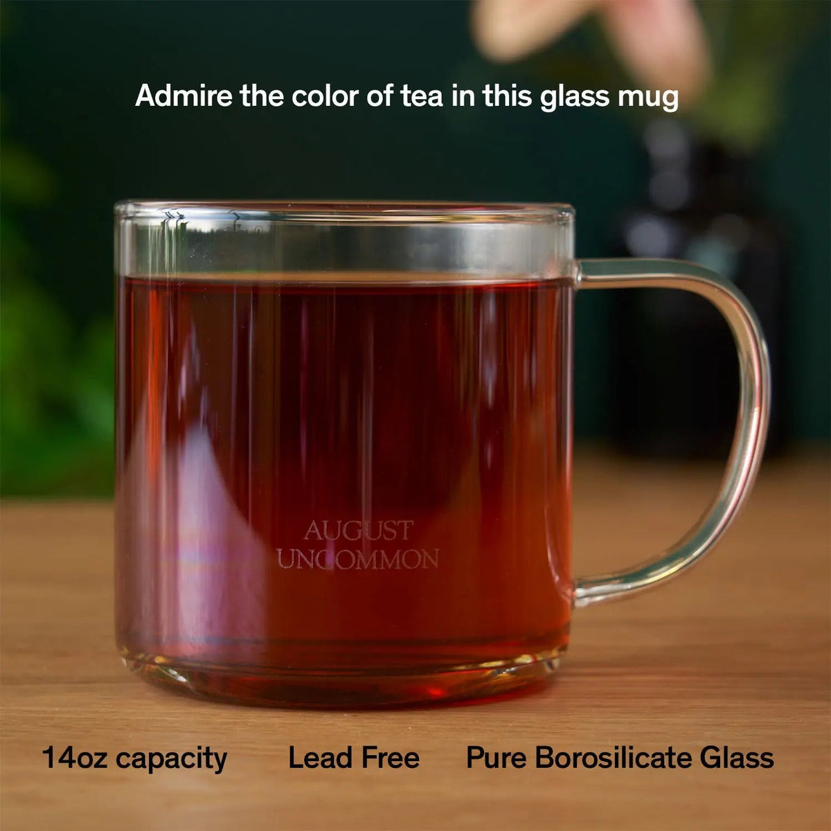 August clear glass tea mug filled with tea; tea not included