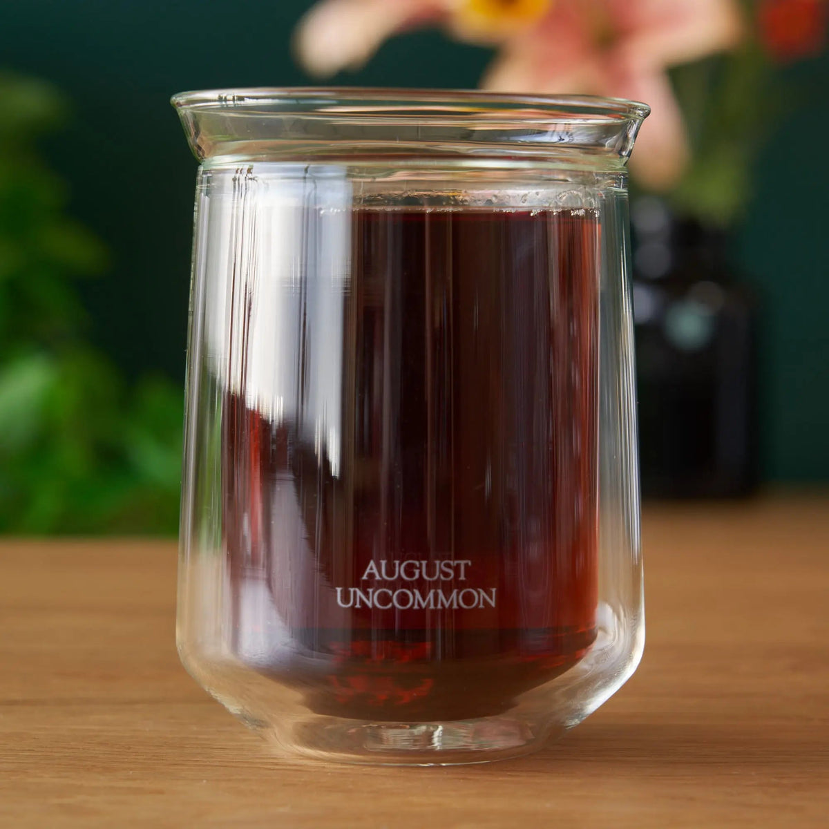 August Uncommon Tea double-wall tasting glass filled with tea; tea is not included