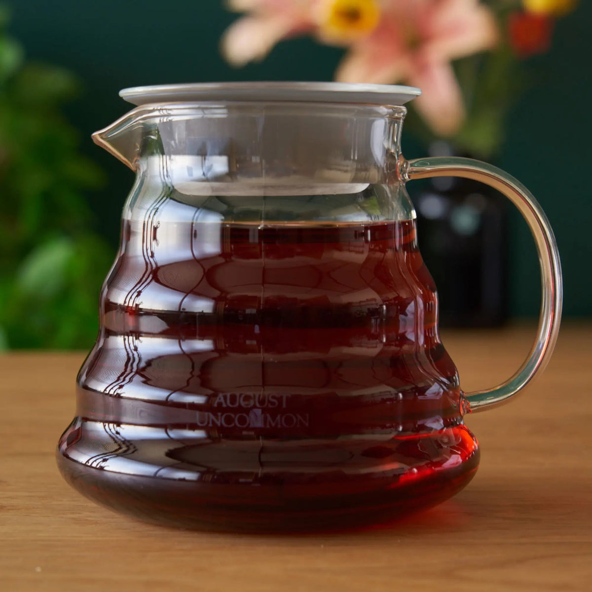 August glass teapot filled with tea; tea not included